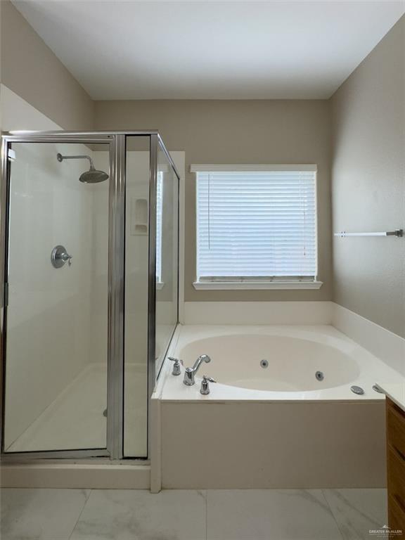 3402 San Sebastian Street Mission, TX 78572 - Photo 15 of 37 a white bath tub sitting next to a shower