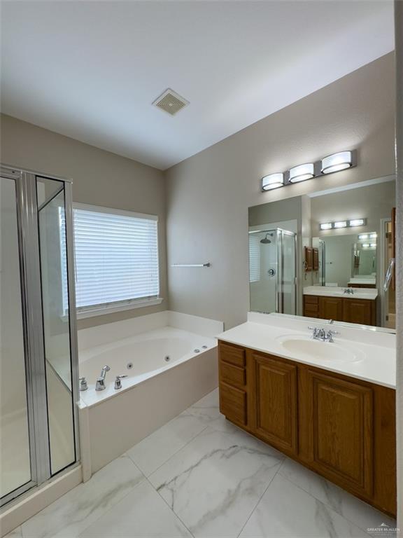 3402 San Sebastian Street Mission, TX 78572 - Photo 16 of 37 a bathroom with a tub sink shower and mirror
