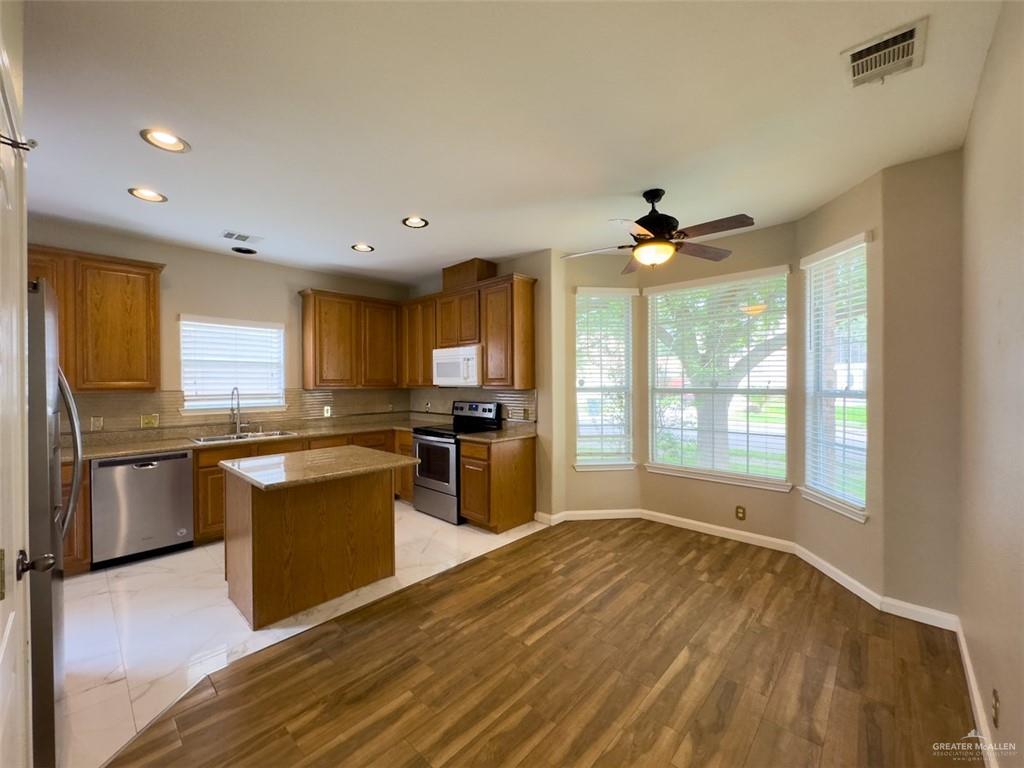 3402 San Sebastian Street Mission, TX 78572 - Photo 2 of 37 a large kitchen with stainless steel appliances granite countertop a sink and a stove