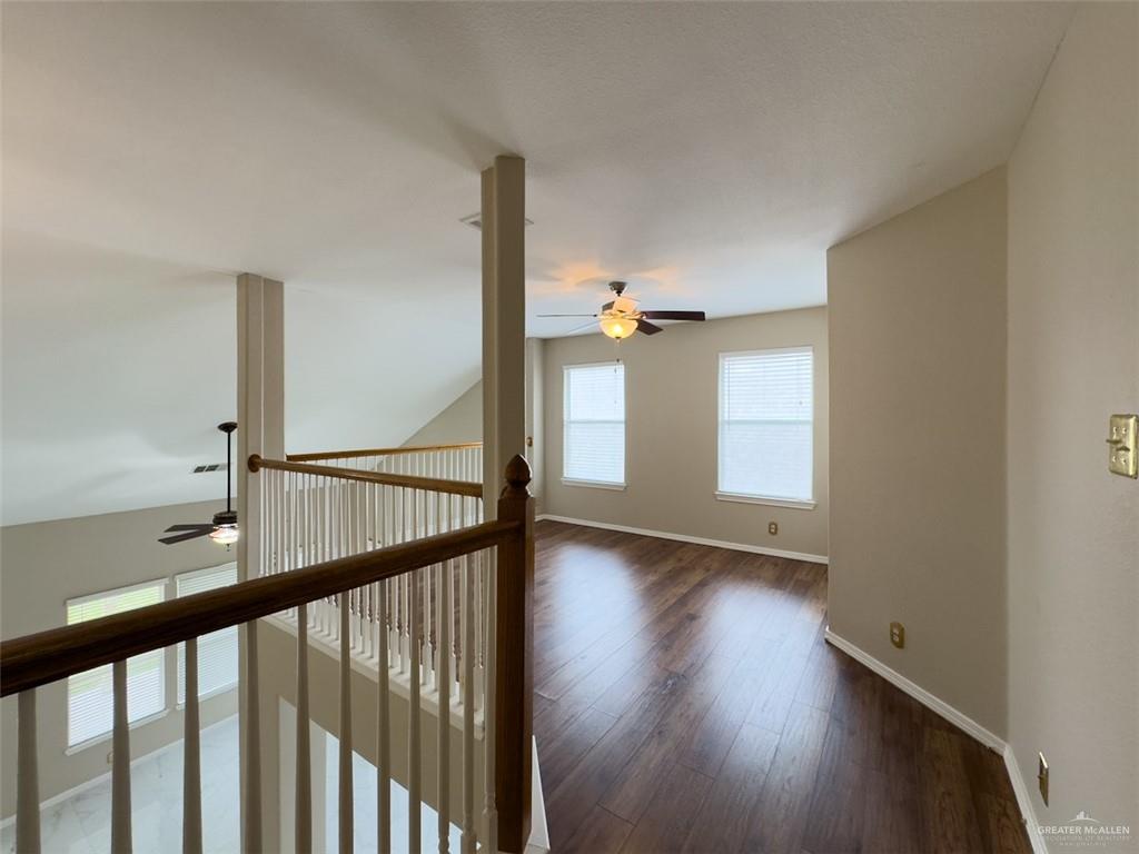 3402 San Sebastian Street Mission, TX 78572 - Photo 21 of 37 a view of an empty room with wooden floor and windows