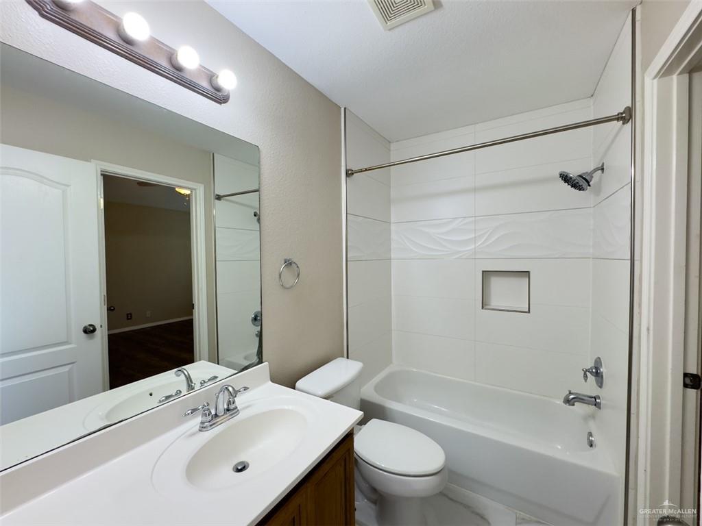 3402 San Sebastian Street Mission, TX 78572 - Photo 24 of 37 a bathroom with a sink toilet and shower