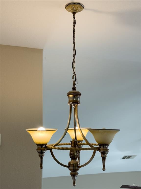 3402 San Sebastian Street Mission, TX 78572 - Photo 29 of 37 a room with a table and a chandelier