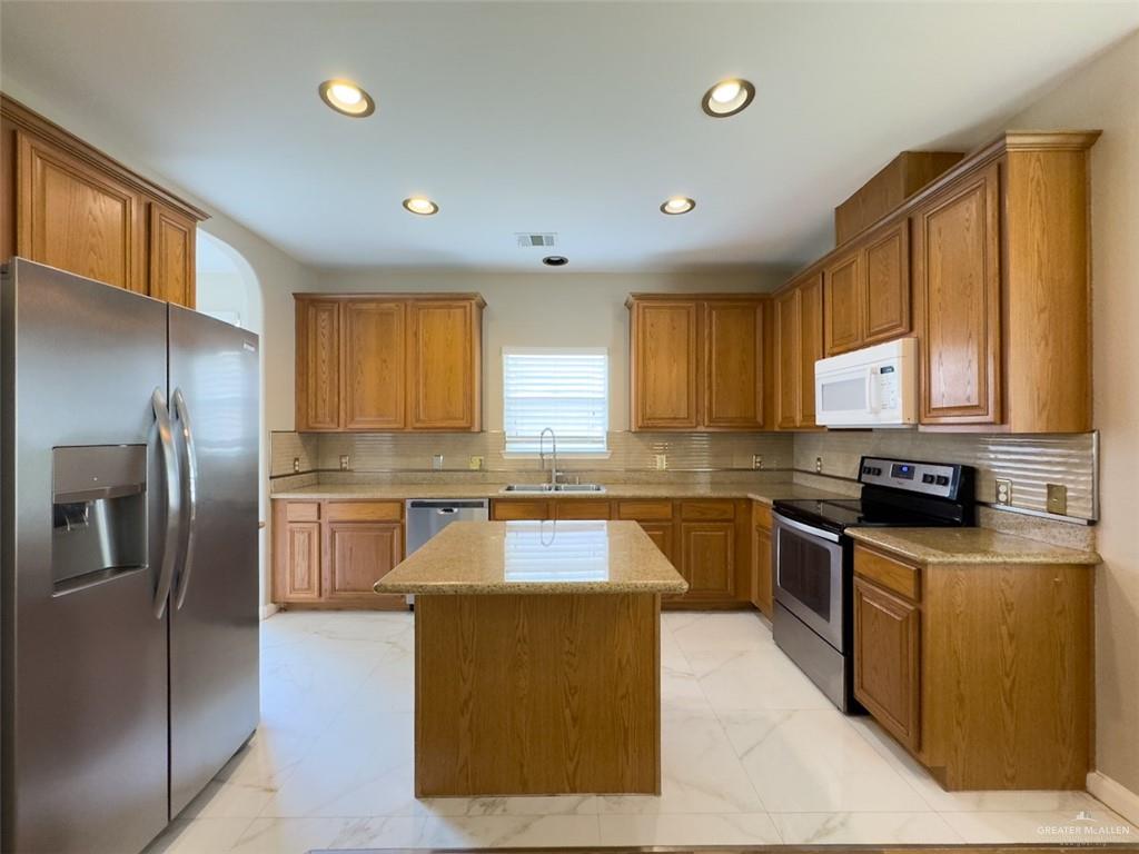 3402 San Sebastian Street Mission, TX 78572 - Photo 3 of 37 a large kitchen with stainless steel appliances granite countertop a sink a stove and refrigerator
