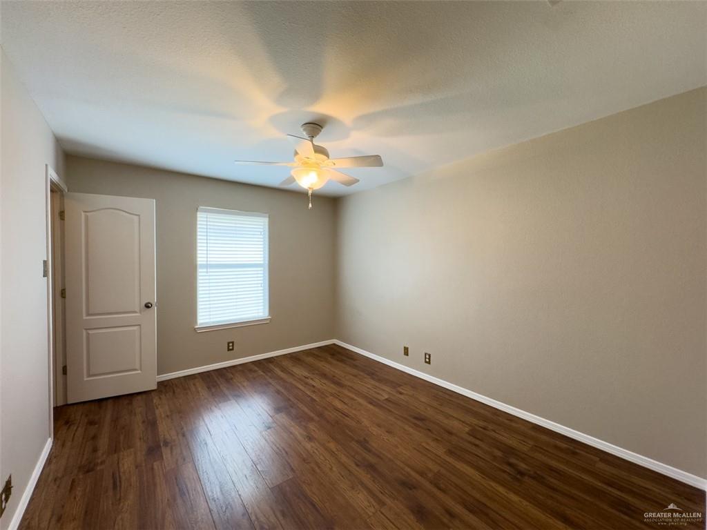 3402 San Sebastian Street Mission, TX 78572 - Photo 31 of 37 a view of an empty room with wooden floor and a window