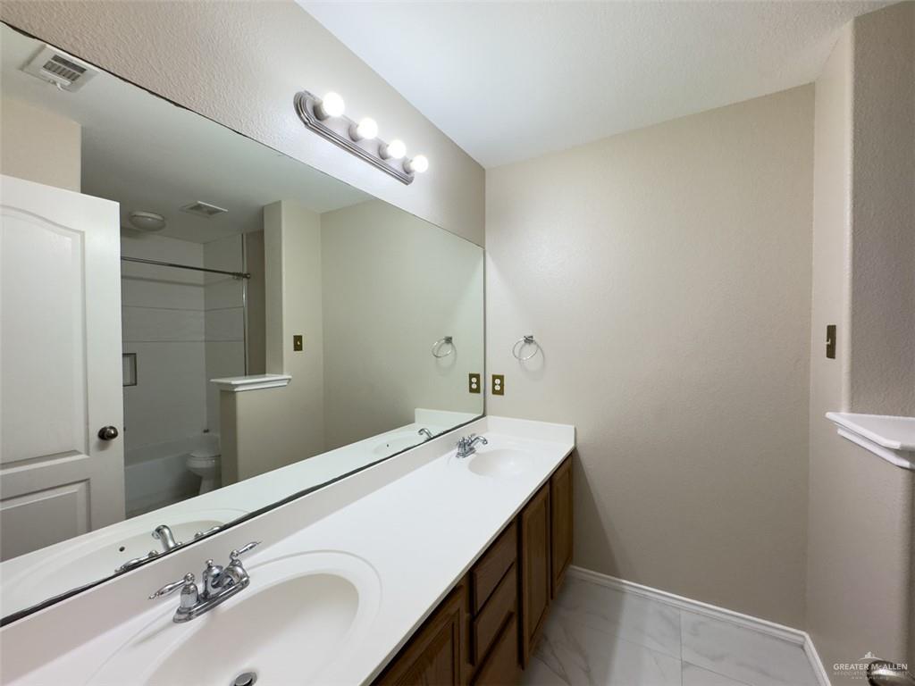 3402 San Sebastian Street Mission, TX 78572 - Photo 32 of 37 a bathroom with a sink and a mirror