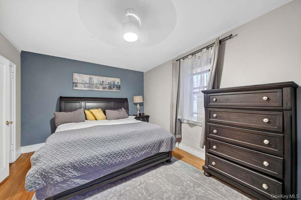 475 Bronx River Road, Unit 2D Yonkers, NY 10704 - Photo 21 of 27 Bedroom featuring light wood-style floors and a ceiling fan