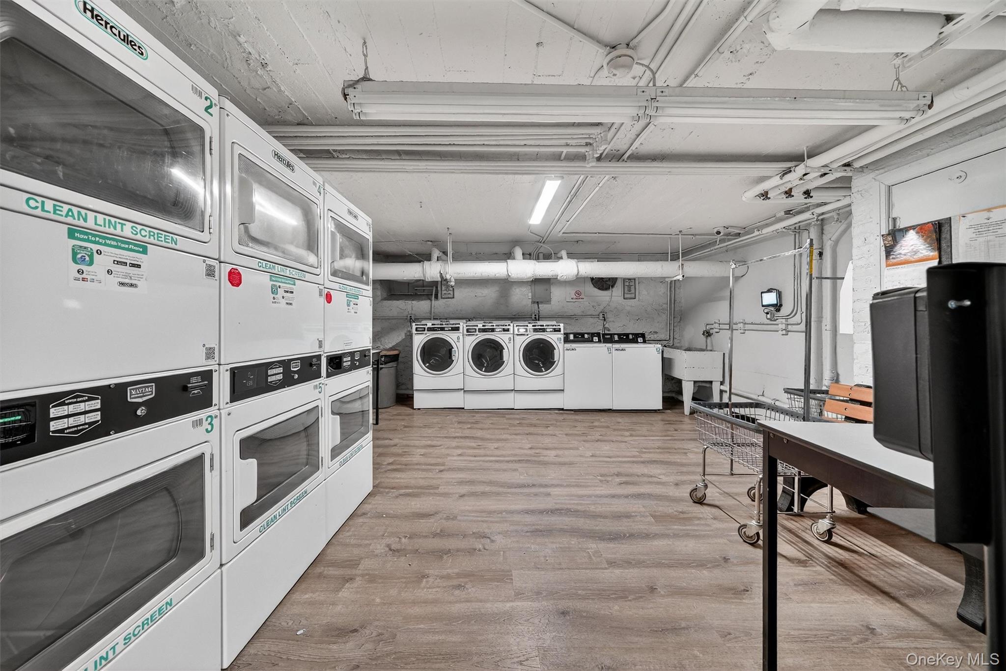 475 Bronx River Road, Unit 2D Yonkers, NY 10704 - Photo 26 of 27 Communal laundry room with stacked washer / dryer and washing machine and dryer