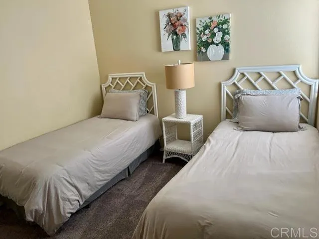 a bedroom with a bed and wall painting