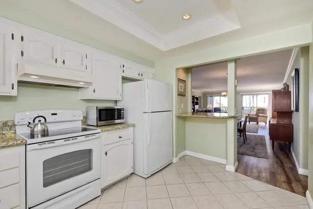 a kitchen with white cabinets and white appliances