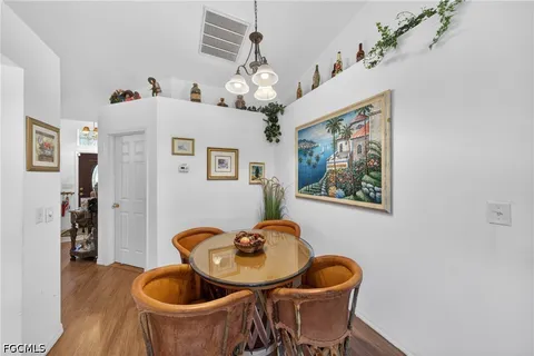 a dining room with furniture and chandelier