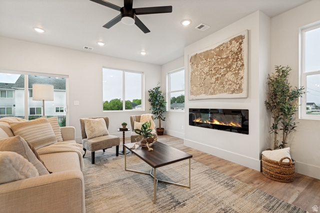 529 North Hvn Drive Mapleton, UT 84664 - Photo 6 of 30 Living area featuring a linear electric fireplace, wood-finish flooring, and a sliding glass door