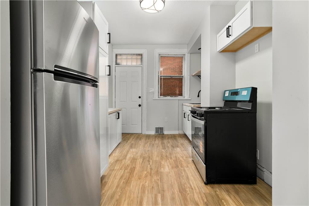 308 North Millvale Avenue Pittsburgh, PA 15224 - Photo 11 of 27 a kitchen with a refrigerator and a stove