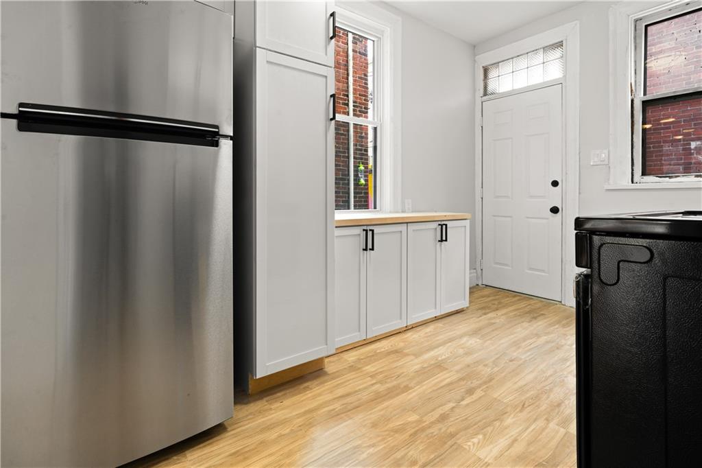 308 North Millvale Avenue Pittsburgh, PA 15224 - Photo 13 of 27 a view of an empty room with wooden floor and a window