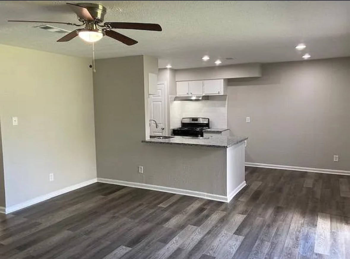 4015 Marchant Road Houston, TX 77047 - Photo 3 of 15 a view of kitchen with granite countertop cabinets and wooden floor