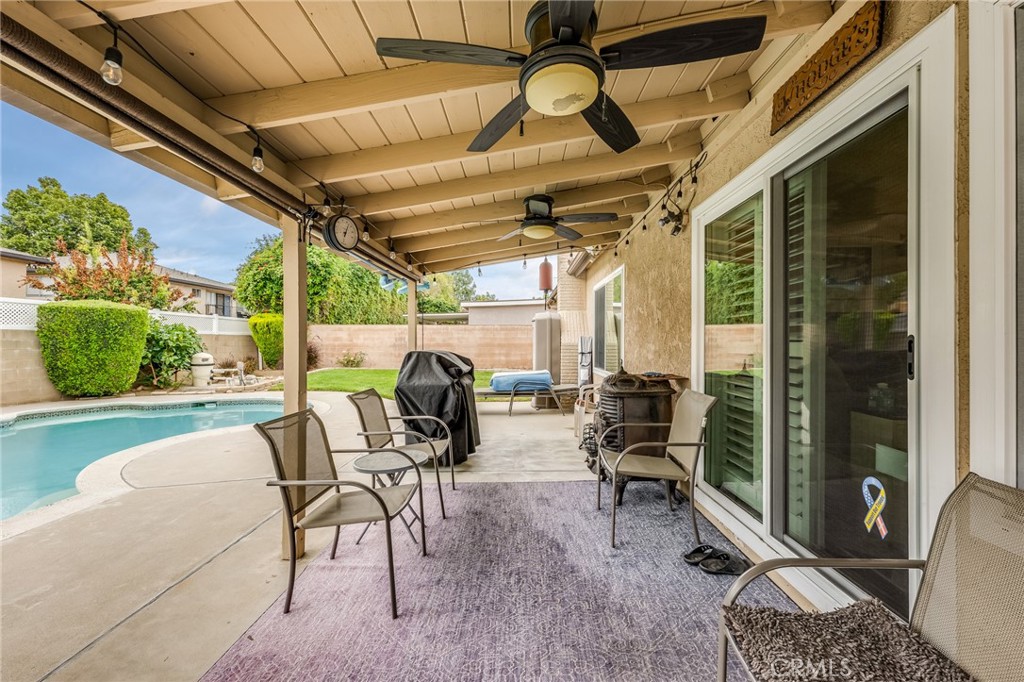 2073 Suede Avenue Simi Valley, CA 93063 - Photo 18 of 33 a view of a patio with table and chairs potted plants and large tree