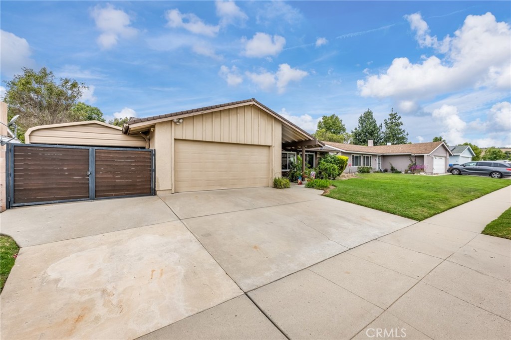 2073 Suede Avenue Simi Valley, CA 93063 - Photo 26 of 33 a front view of a house with a yard and garage