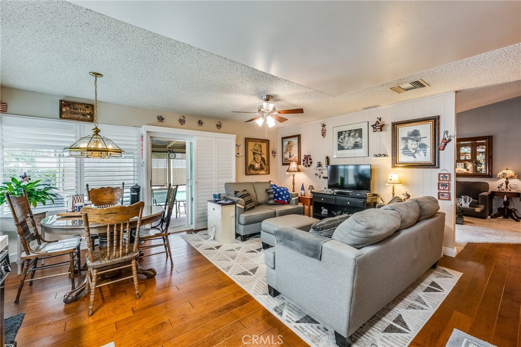 2073 Suede Avenue Simi Valley, CA 93063 - Photo 7 of 33 a living room with furniture kitchen view and a wooden floor