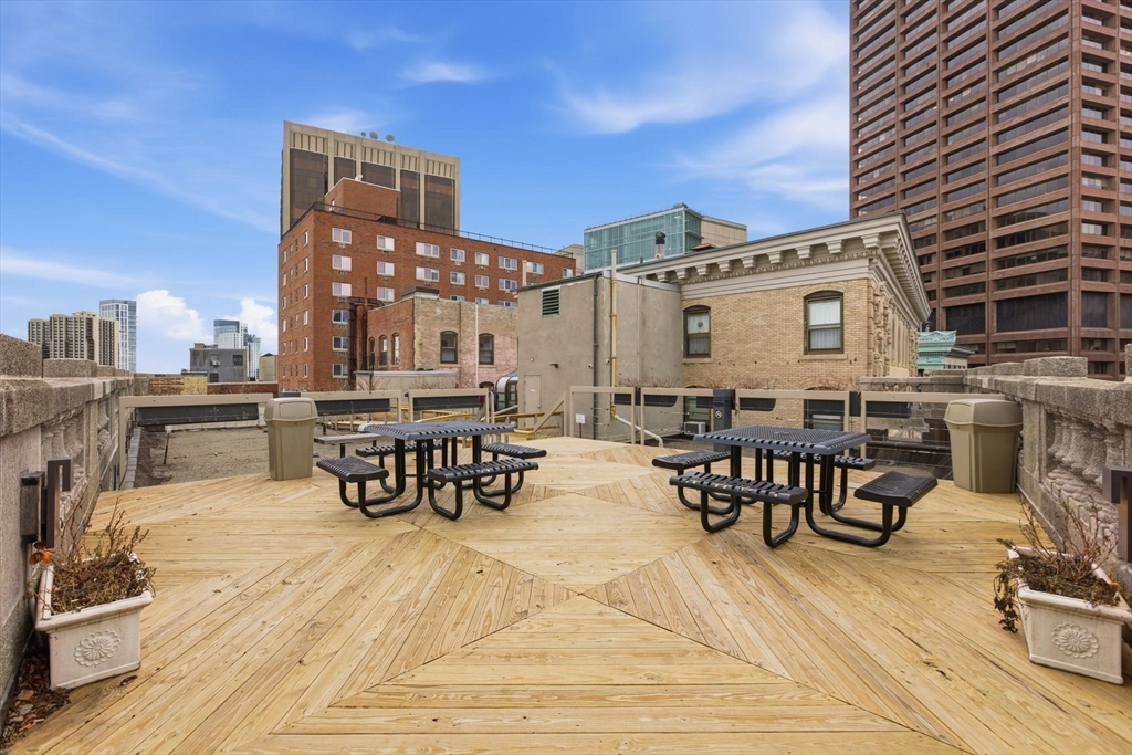 21 Beacon Street, Unit 11L Boston, MA 02108 - Photo 15 of 23 a view of a chairs and table on the wooden floor