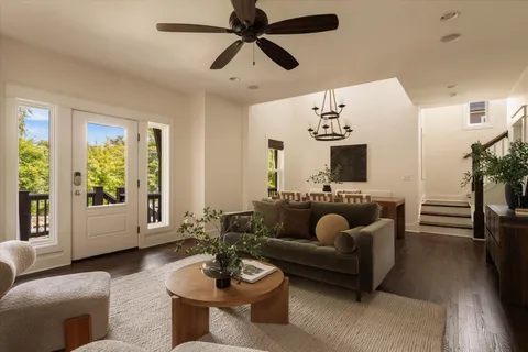 a kitchen with stainless steel appliances granite countertop a dining table and chairs