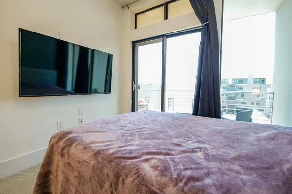 a bedroom with a bed and a window