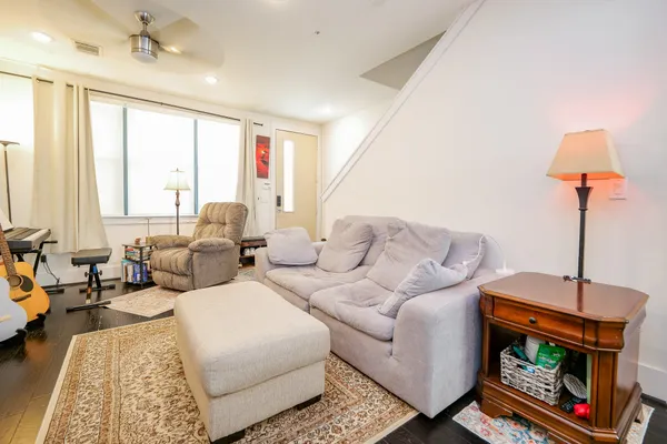 a living room with furniture a large window and a flat screen tv