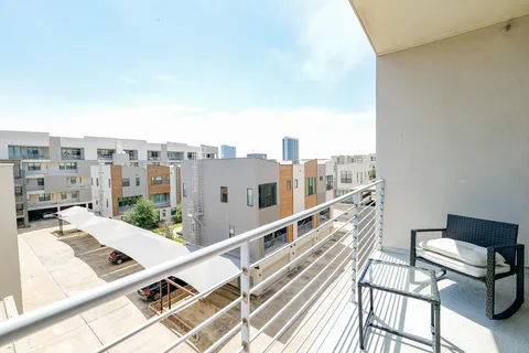 a view of balcony with wooden floor and city view