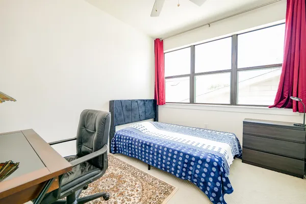 a bedroom with a bed and a window