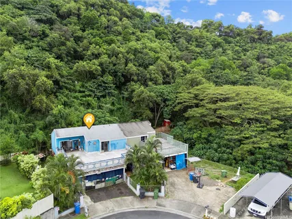 an aerial view of a house with a yard