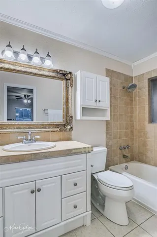 a bathroom with a granite countertop toilet sink and mirror
