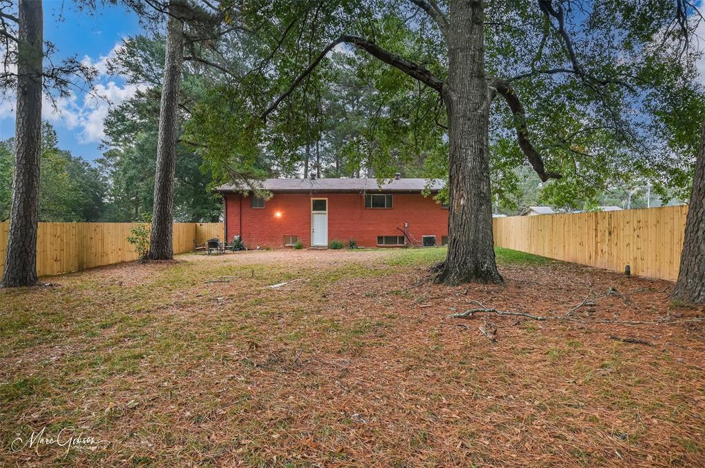 821 Princeton Road Princeton, LA 71067 - Photo 23 of 26 a front view of a house with large garden and mountain view