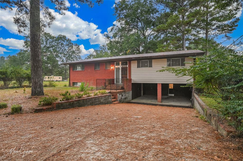 821 Princeton Road Princeton, LA 71067 - Photo 26 of 26 a view of house with a yard and potted plants
