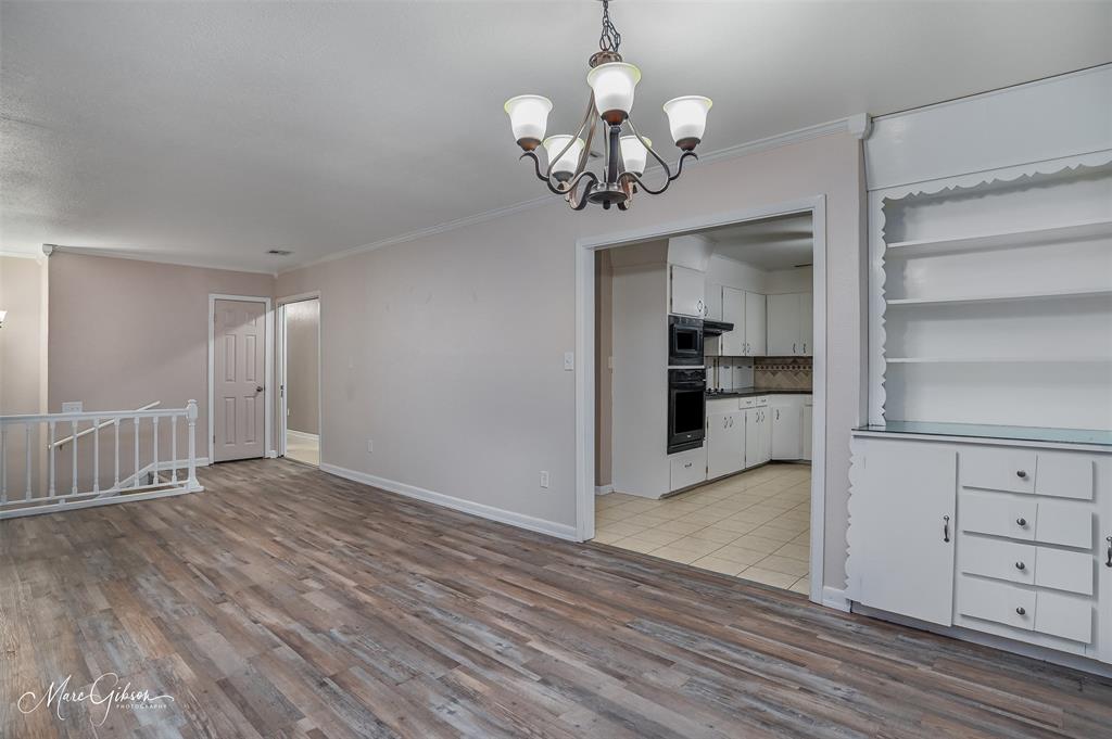 821 Princeton Road Princeton, LA 71067 - Photo 6 of 26 a view of a room with wooden floor and chandelier
