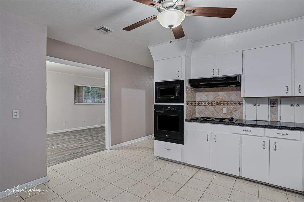 821 Princeton Road Princeton, LA 71067 - Photo 9 of 26 a kitchen with granite countertop a sink and cabinets
