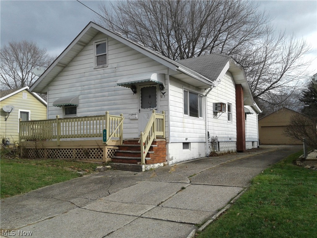 613 Jackson Street Amherst, OH 44001 - Photo 1 of 29 Bungalow featuring, a shingled roof, a detached garage, a deck, and basement