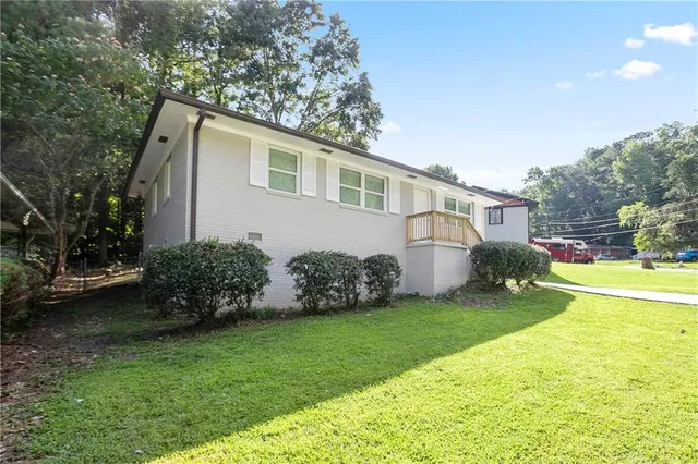 a front view of a house with garden
