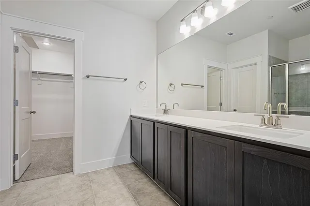 a bathroom with a shower and a glass door