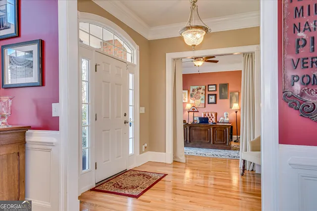 a view of a dining room with furniture and chandelier