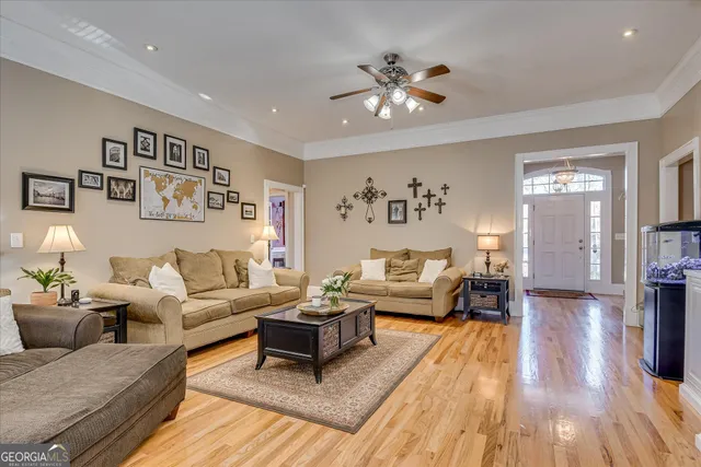 a dining room with wooden floor a chandelier a wooden table and chairs