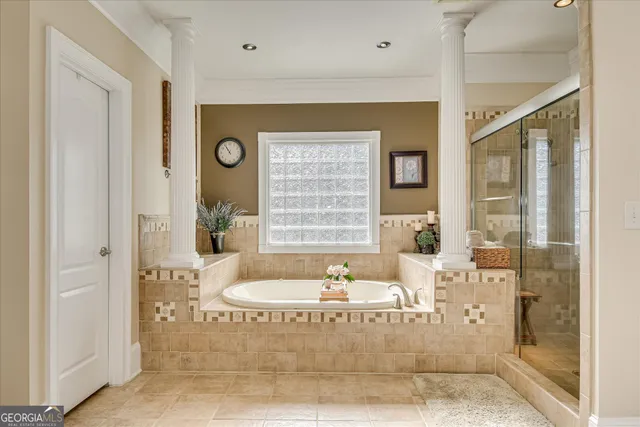 a bathroom with a sink toilet double vanity and shower