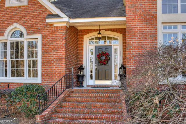 a view of an entryway with wooden floor and a front door