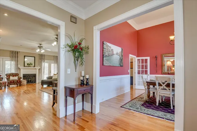 a view of a dining room with furniture a chandelier and wooden floor