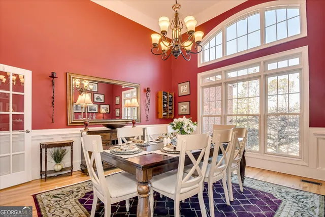a view of a dining room with furniture wooden floor and chandelier