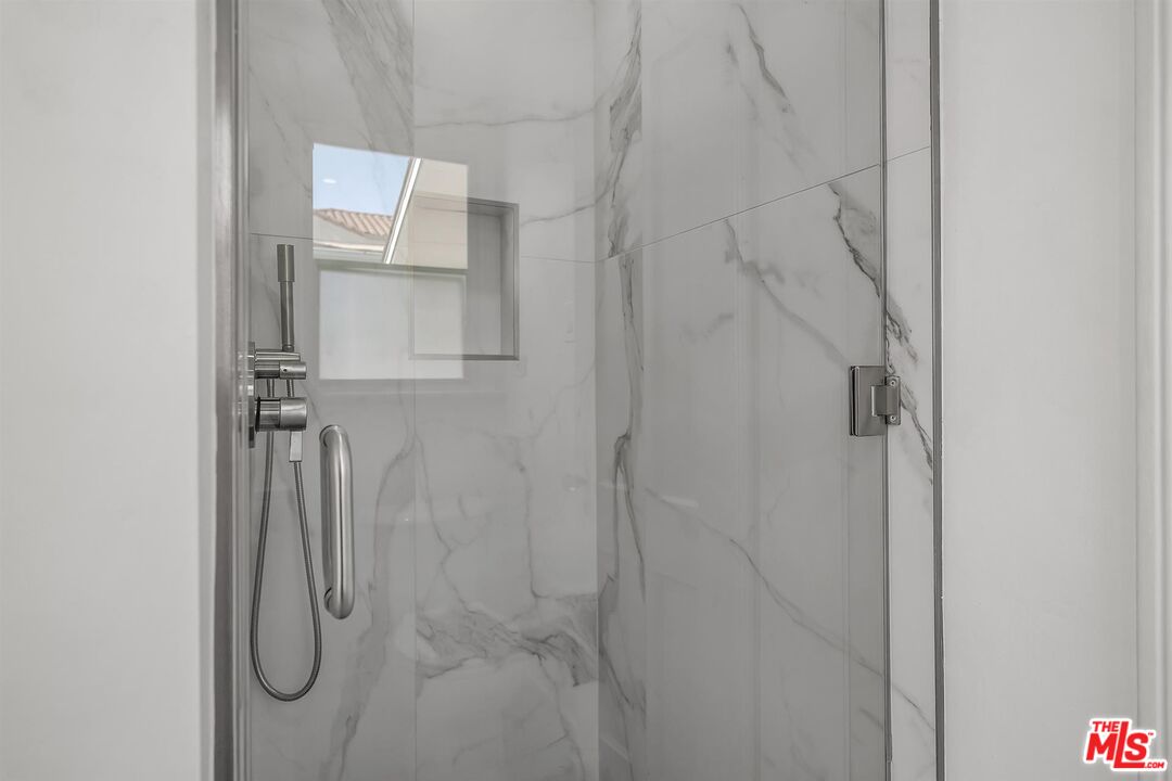 121 North Doheny Drive Beverly Hills, CA 90211 - Photo 15 of 20 a bathroom with a glass shower door