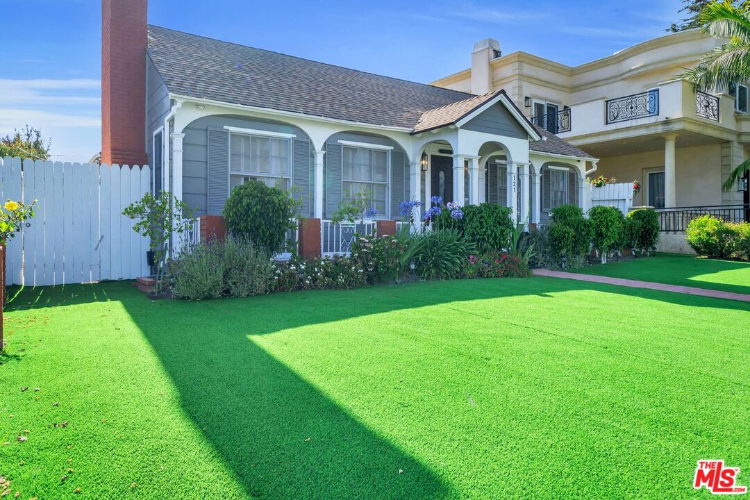 121 North Doheny Drive Beverly Hills, CA 90211 - Photo 19 of 20 a front view of a house with garden and porch