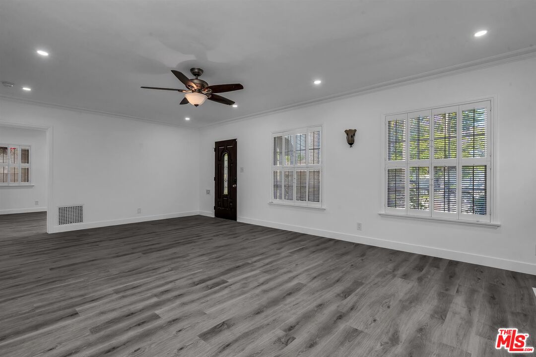 121 North Doheny Drive Beverly Hills, CA 90211 - Photo 4 of 20 a view of an empty room with a window and wooden floor
