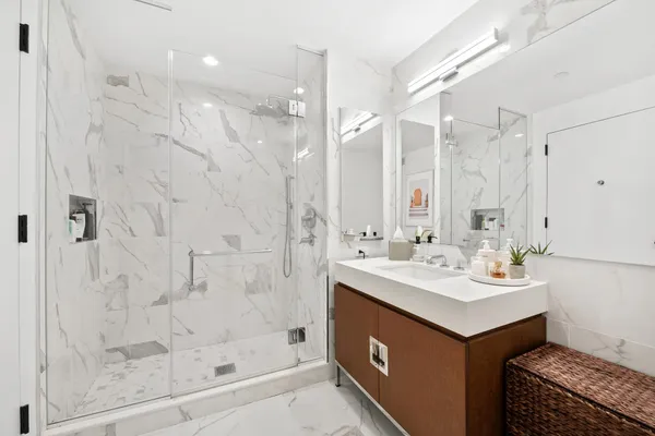 a bathroom with a sink double vanity and shower