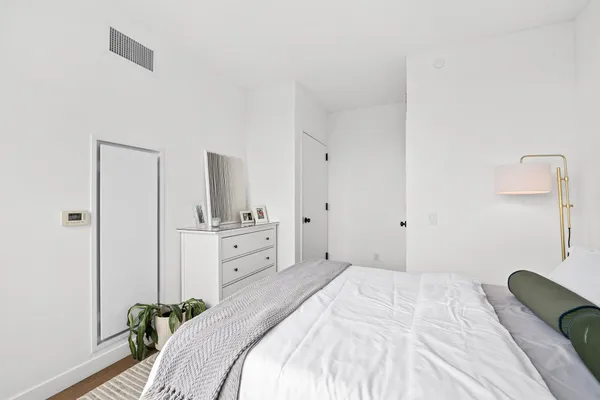 a bedroom with a bed and a chair