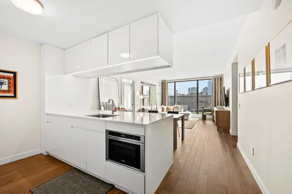 a kitchen with sink stove and cabinets
