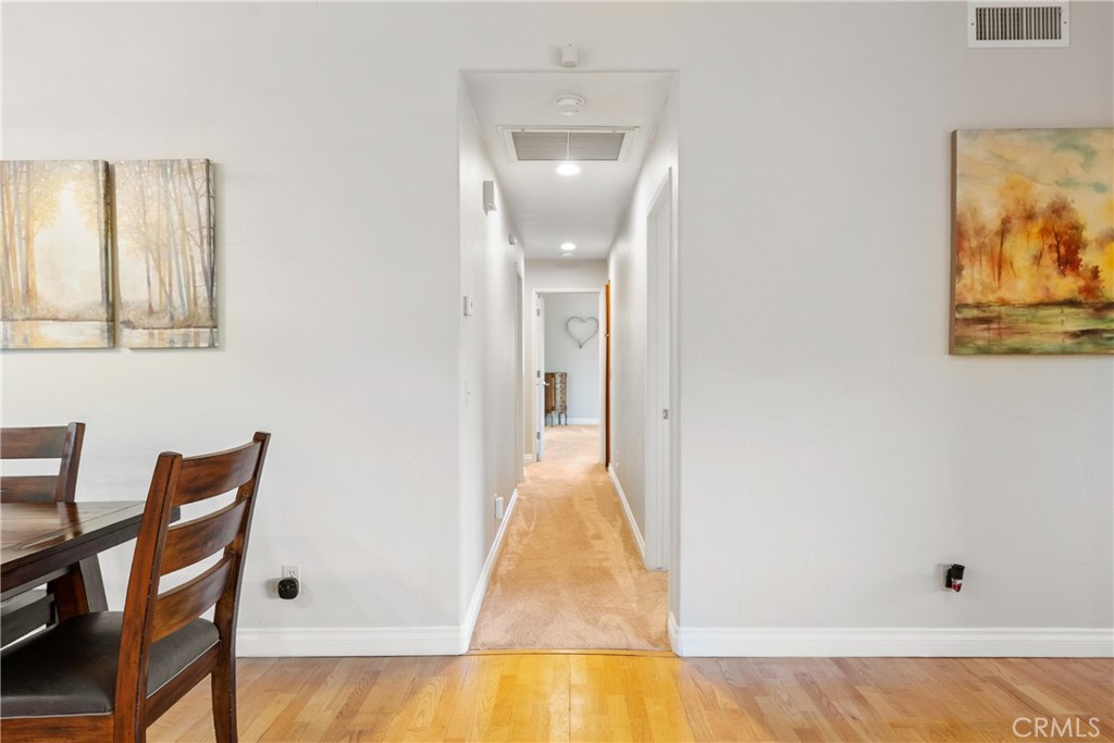 8505 Santa Cruz Road Atascadero, CA 93422 - Photo 20 of 59 a view of a hallway with wooden floor and a bathroom