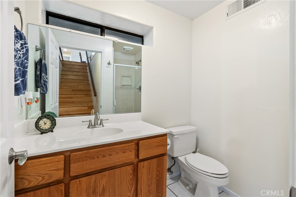 8505 Santa Cruz Road Atascadero, CA 93422 - Photo 32 of 59 a bathroom with a sink a toilet and mirror